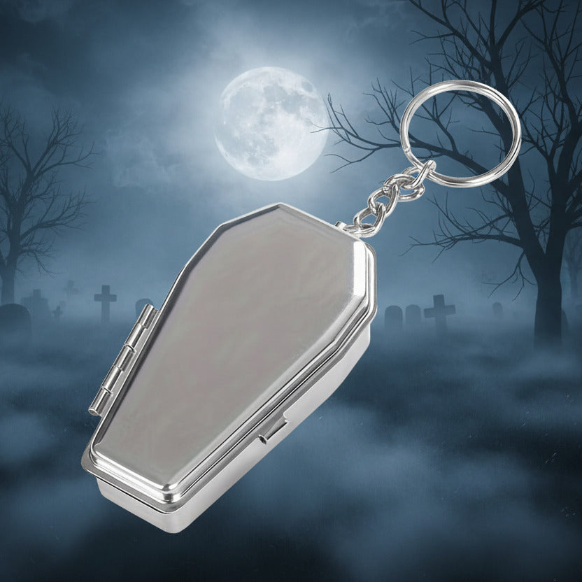 Silver coffin-shaped keychain  on a white background